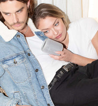 Woman laying on man's chest listening to the Mini Kommuter